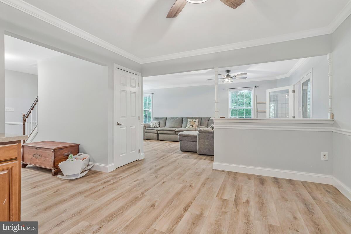 5963 Hillside Road St. Leonard, MD 20685 - Photo 16 of 54 a view of a room with wooden floor and furniture