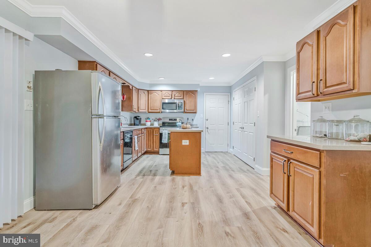 5963 Hillside Road St. Leonard, MD 20685 - Photo 17 of 54 a kitchen with stainless steel appliances granite countertop a refrigerator a stove top oven a sink dishwasher and a refrigerator with wooden floor