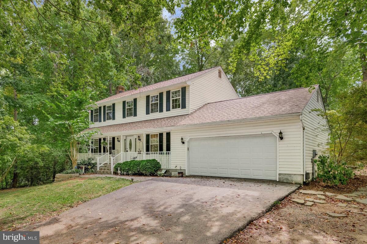 5963 Hillside Road St. Leonard, MD 20685 - Photo 2 of 54 a front view of a house with a yard and garage