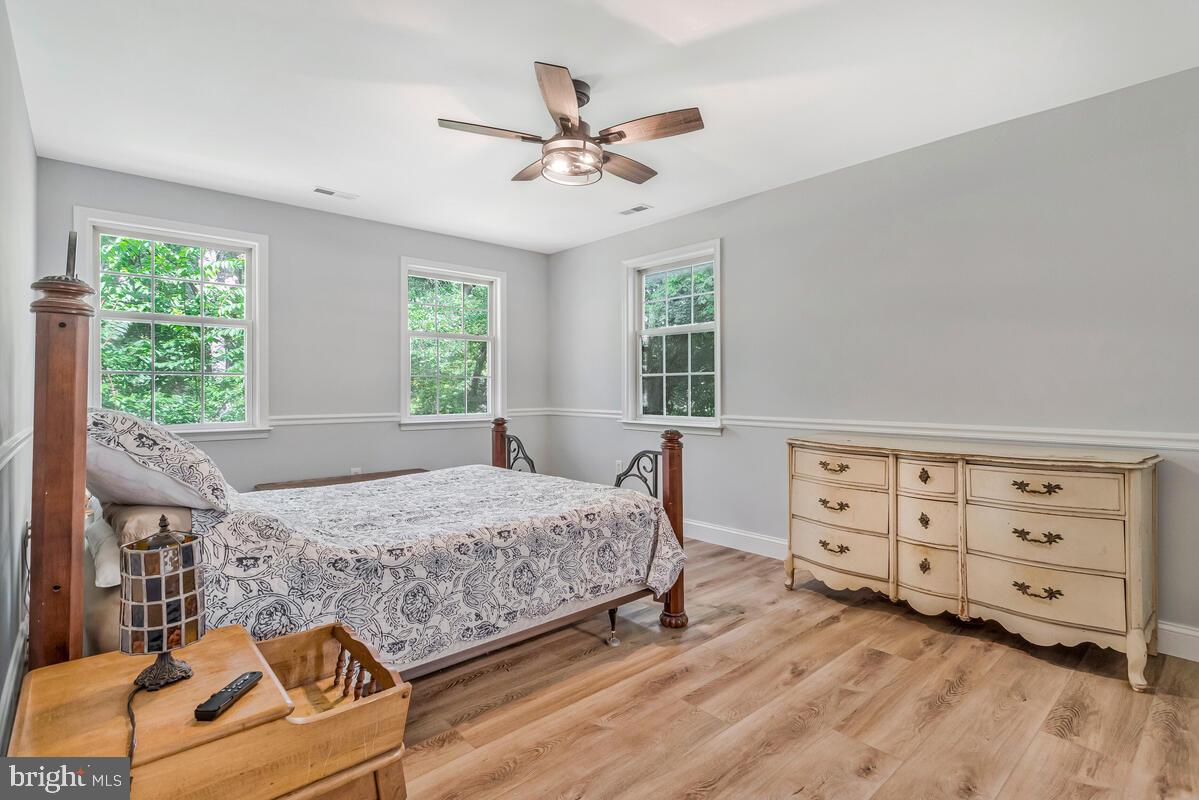 5963 Hillside Road St. Leonard, MD 20685 - Photo 26 of 54 a bedroom with a bed and a dresser