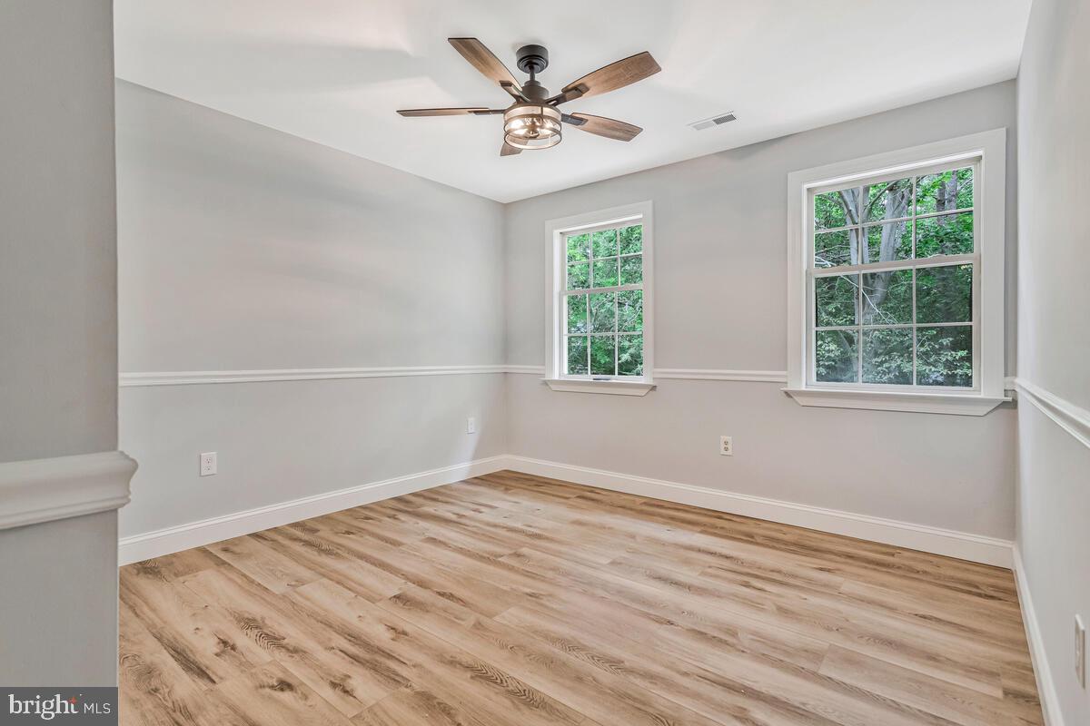 5963 Hillside Road St. Leonard, MD 20685 - Photo 34 of 54 wooden floor in an empty room with a window