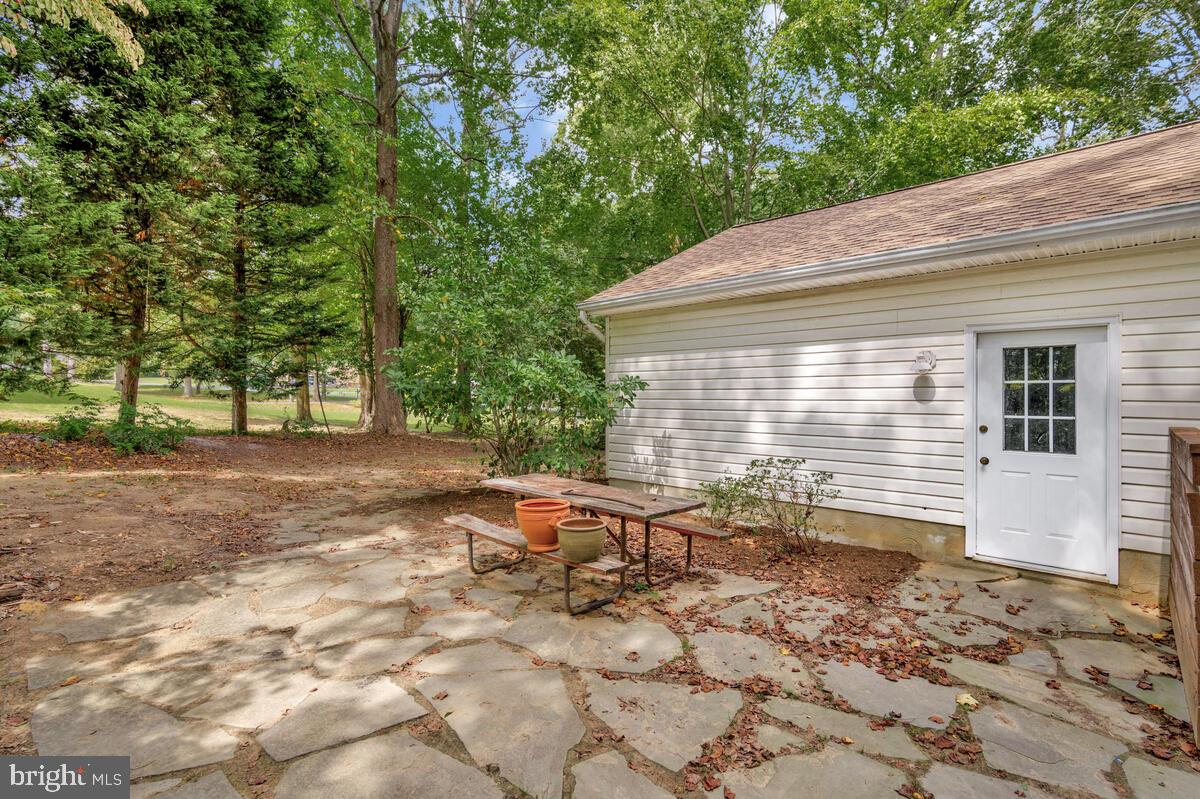 5963 Hillside Road St. Leonard, MD 20685 - Photo 50 of 54 a backyard of a house with table and chairs