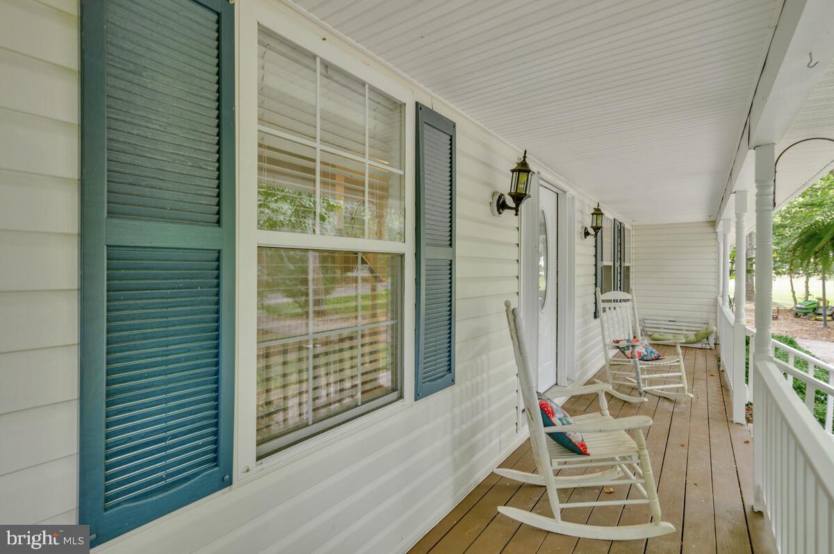5963 Hillside Road St. Leonard, MD 20685 - Photo 5 of 54 a view of a room with wooden floor and windows