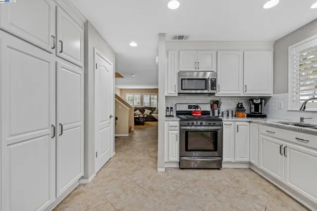 a kitchen with stainless steel appliances granite countertop a stove and a refrigerator