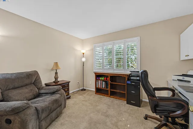 a livingroom with workspace and a window