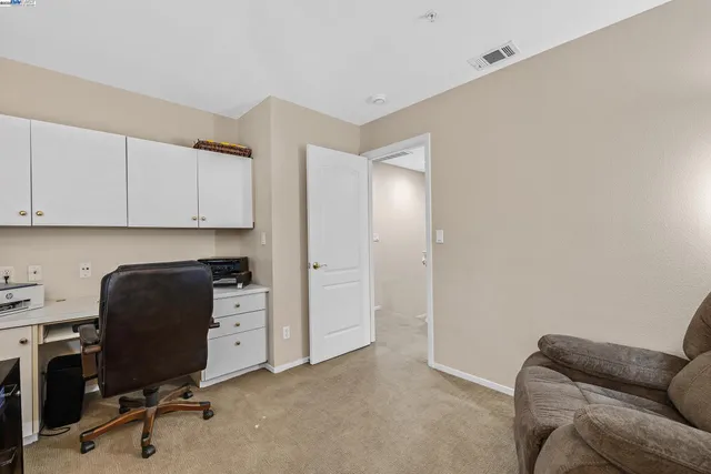 a view of workspace with furniture and cabinet
