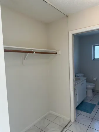 a bathroom with a granite countertop toilet and a sink