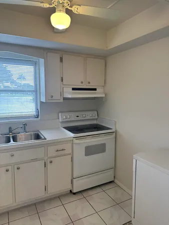 a kitchen with cabinets appliances and a sink