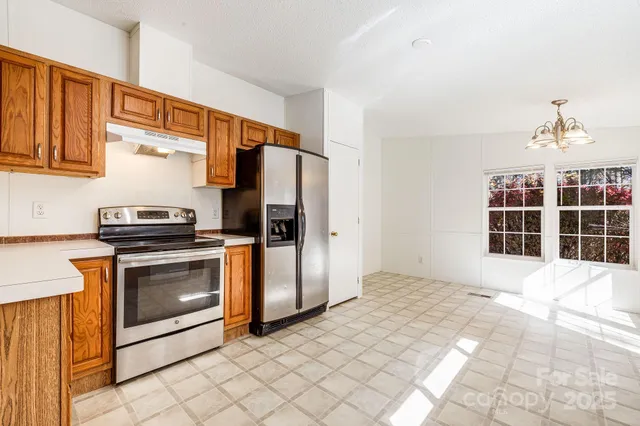 a large kitchen with kitchen island a sink stainless steel appliances and cabinets