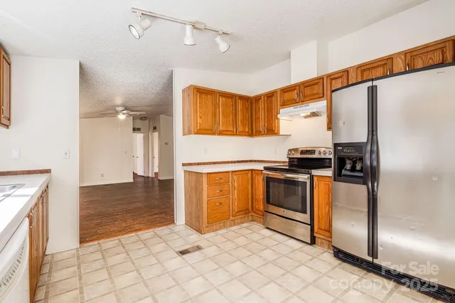 a bathroom with a granite countertop sink and a tub