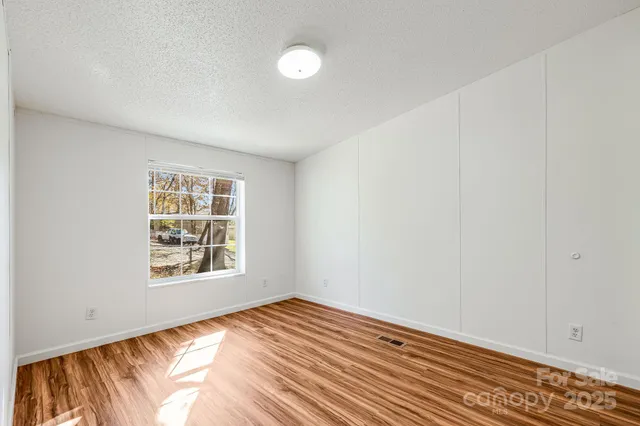 a view of a room with wooden floor and bathroom