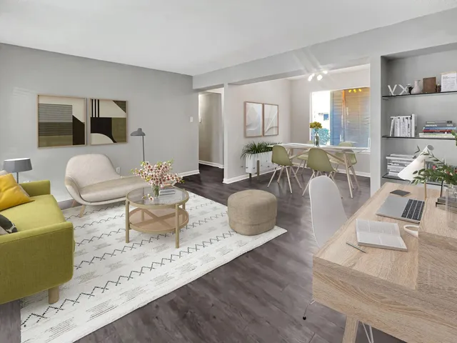 a living room with furniture wooden floor and a large window