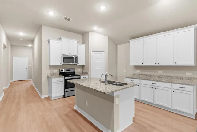 a kitchen with a sink stove and refrigerator