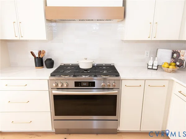 a stove top oven sitting inside of a kitchen