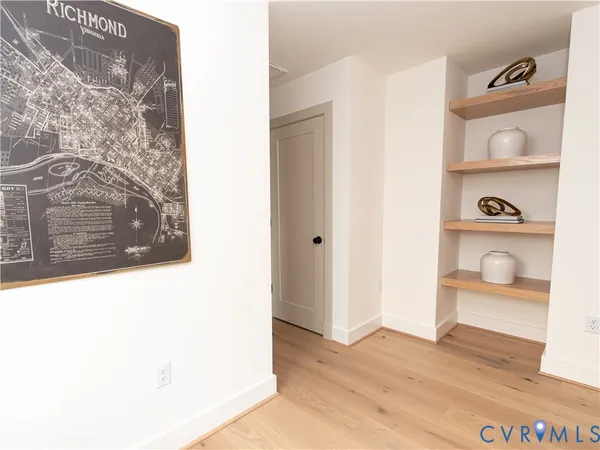 a view of a closet area with wooden floor