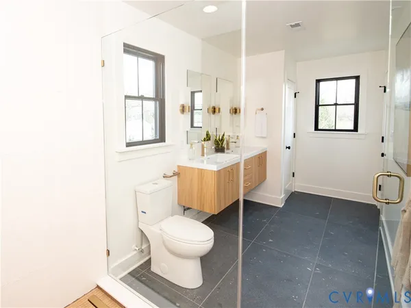 a bathroom with a sink toilet and shower