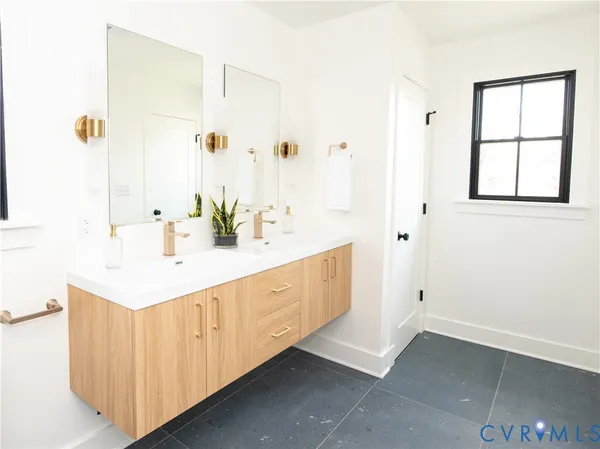 a bathroom with a sink a mirror and a window