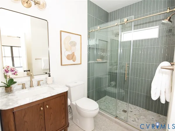 a bathroom with a sink toilet and shower