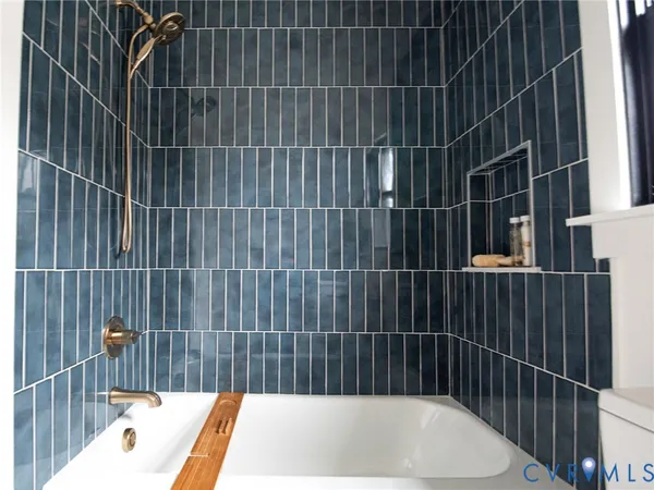 a bathroom with a bathtub and shower