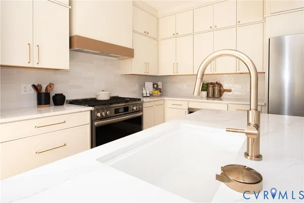 a kitchen with a stove a refrigerator and cabinets