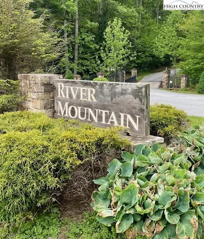 a sign broad in front of flowers