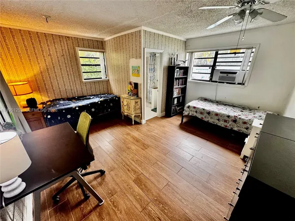 a bedroom with furniture and a window