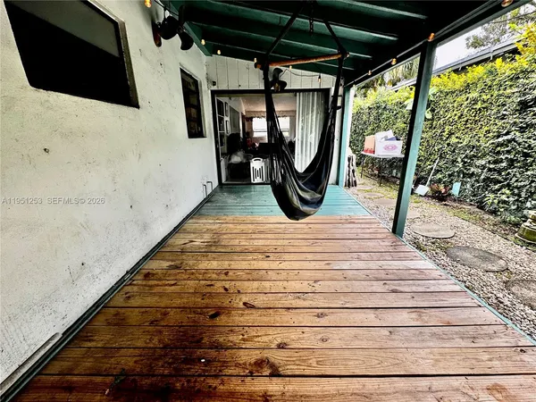 a view of a porch with wooden floor