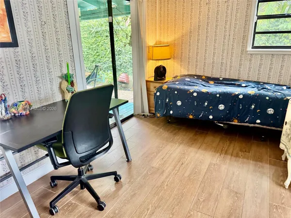 a bedroom with a bed chair and a window