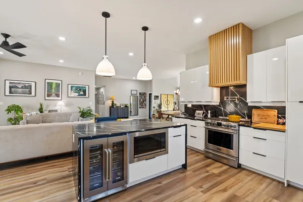 a kitchen with stainless steel appliances granite countertop a stove a sink and a refrigerator