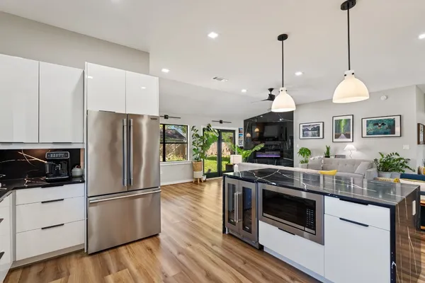 a kitchen with stainless steel appliances granite countertop a stove a refrigerator and a sink