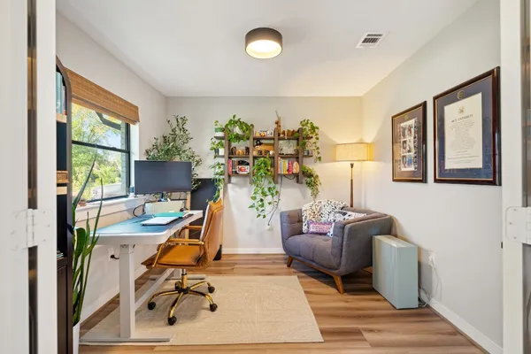 a view of a livingroom with furniture and a potted plant