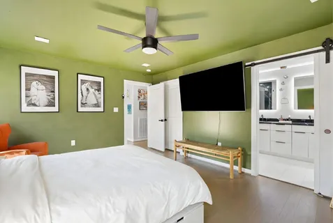 a bedroom with a bed and a flat screen tv