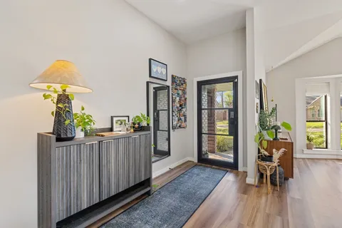 a living room with furniture and a wooden floor