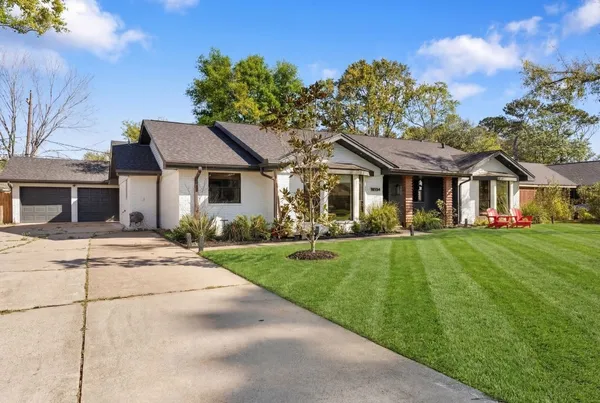a front view of a house with a garden