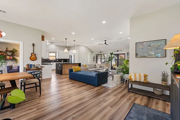 a living room with furniture and a wooden floor