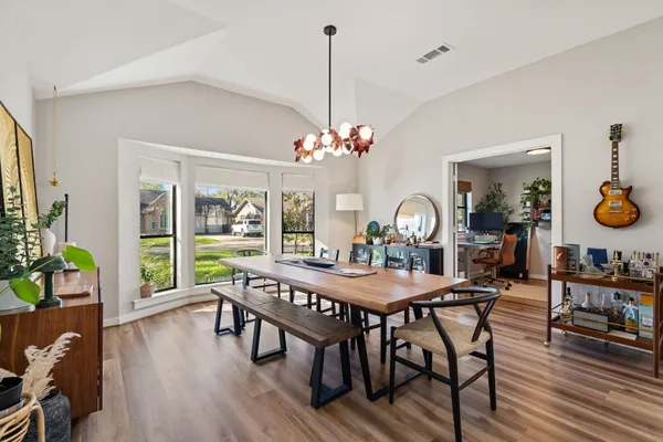 a view of a dining room with furniture window and wooden floor