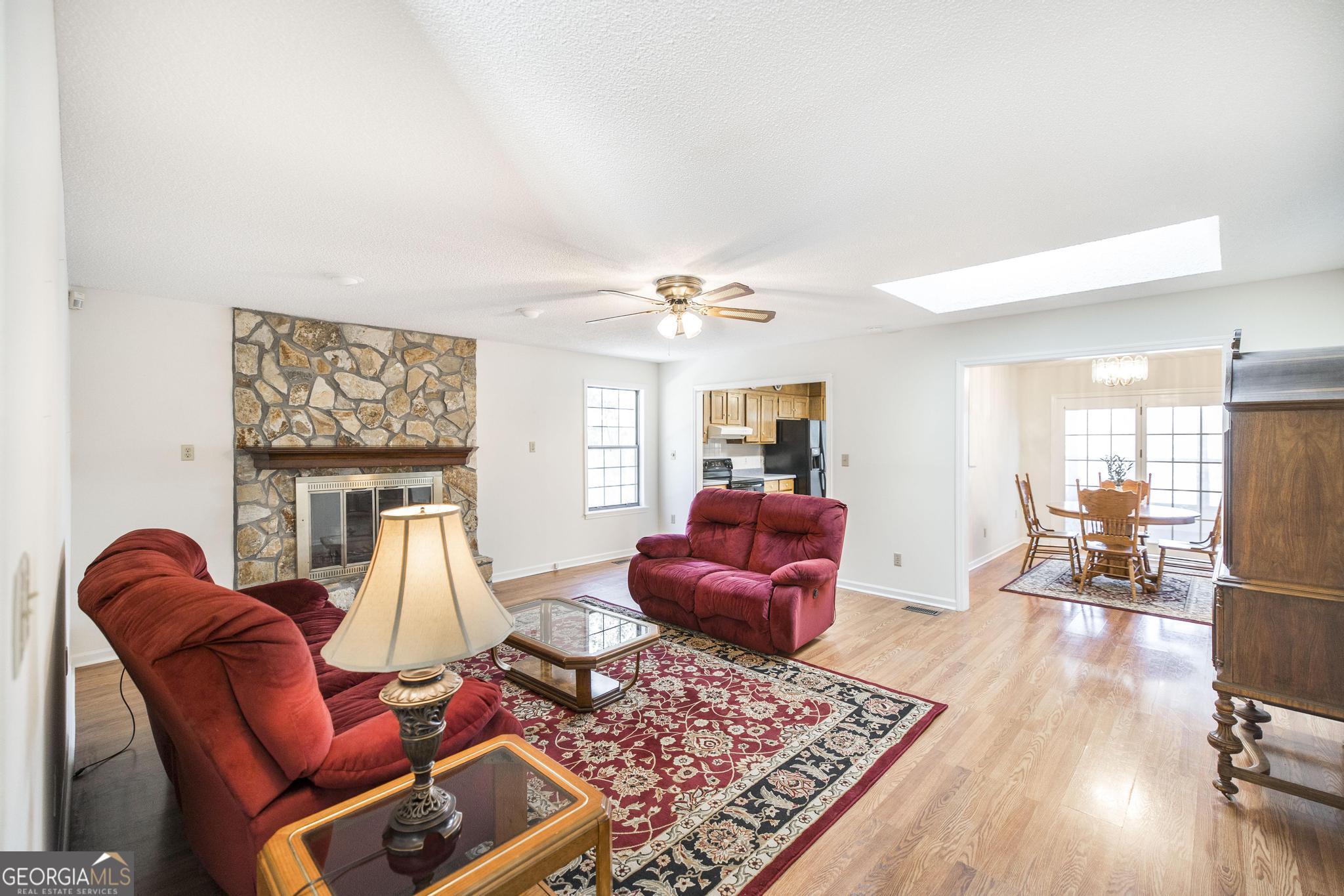 240 Mossland Drive Perry, GA 31069 - Photo 14 of 36 a living room with furniture a rug and a fireplace