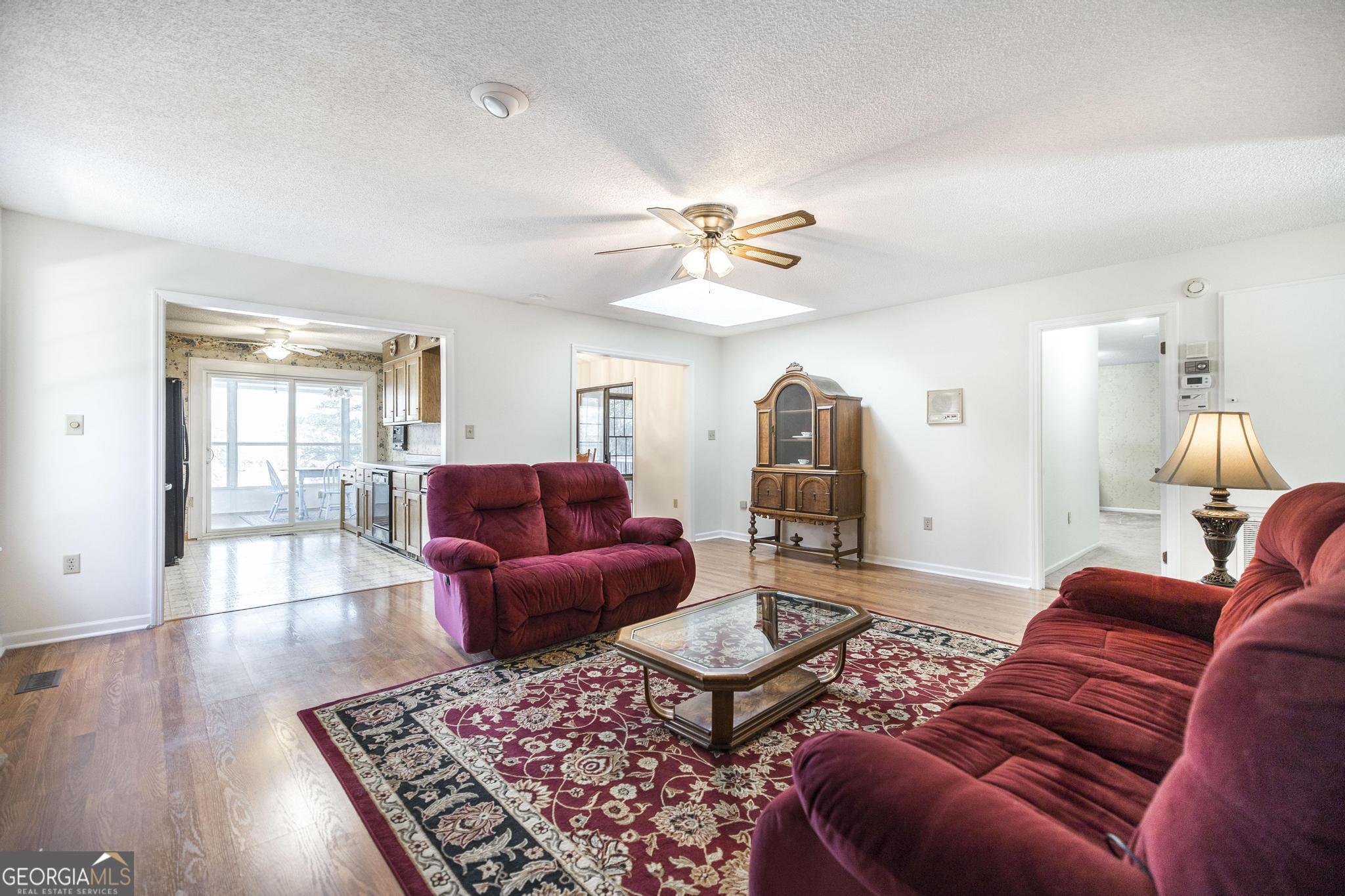 240 Mossland Drive Perry, GA 31069 - Photo 15 of 36 a living room with furniture ceiling fan and wooden floor