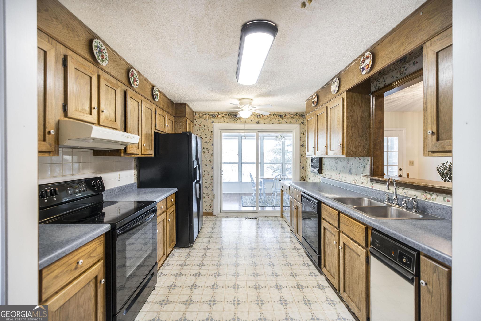 240 Mossland Drive Perry, GA 31069 - Photo 18 of 36 a kitchen with stainless steel appliances granite countertop a sink stove and cabinets