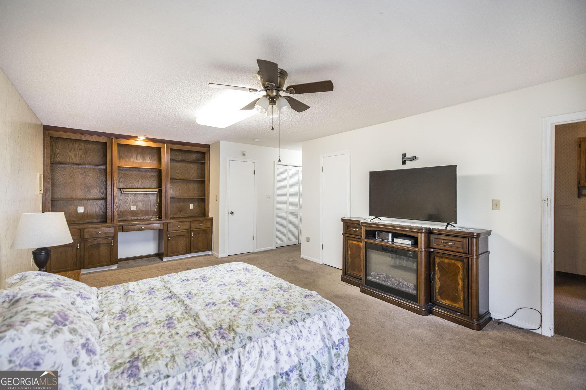 240 Mossland Drive Perry, GA 31069 - Photo 23 of 36 a bedroom with a bed and a flat screen tv