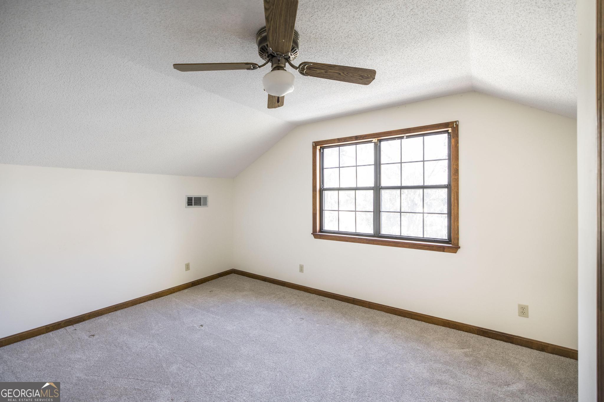 240 Mossland Drive Perry, GA 31069 - Photo 27 of 36 an empty room with a window and a ceiling fan