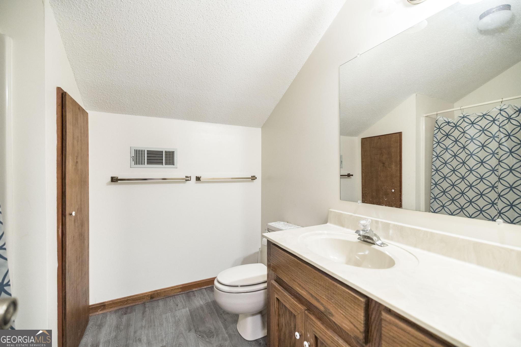 240 Mossland Drive Perry, GA 31069 - Photo 29 of 36 a bathroom with a sink a toilet and mirror
