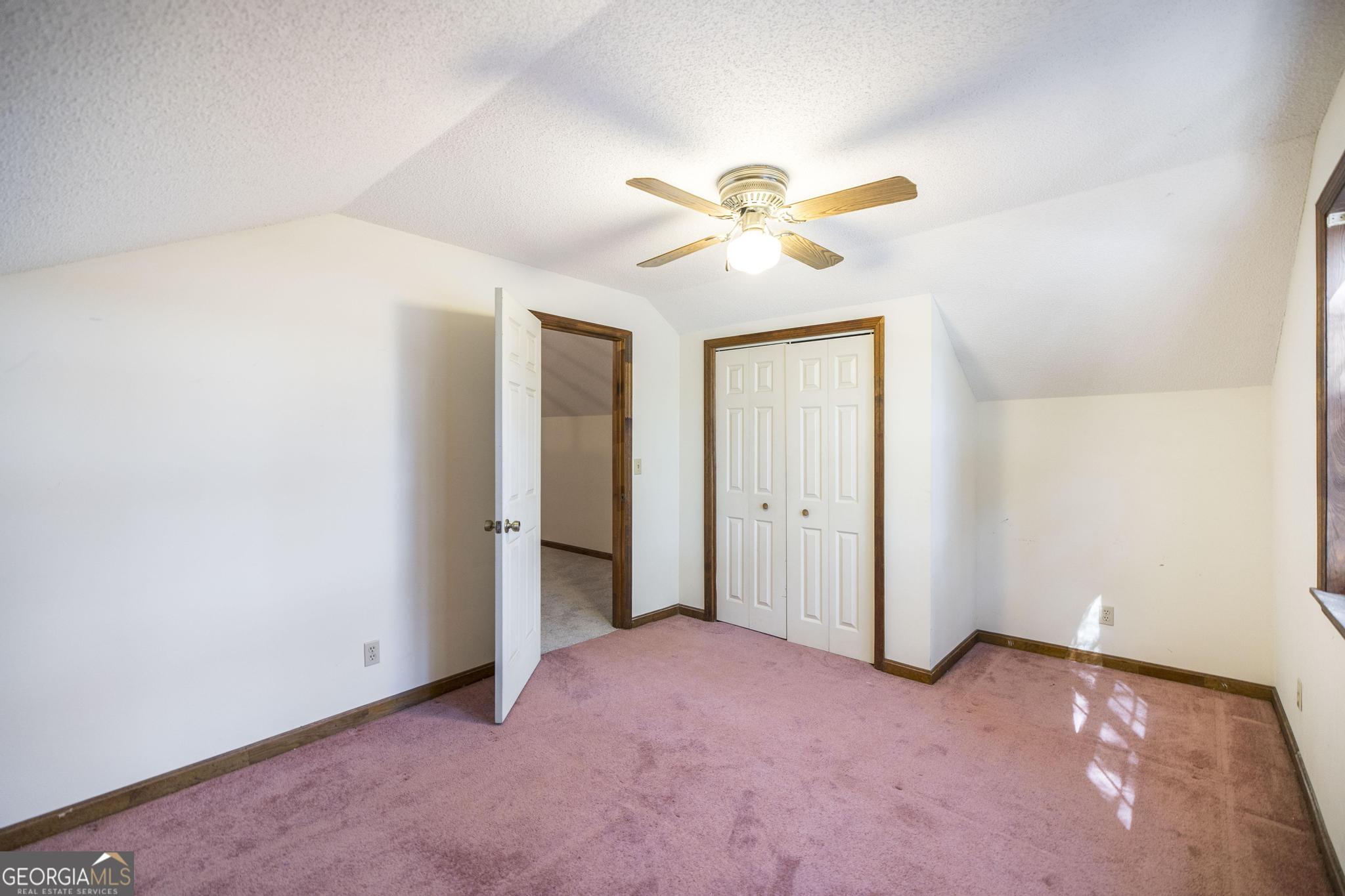 240 Mossland Drive Perry, GA 31069 - Photo 30 of 36 an empty room with closet and a chandelier fan