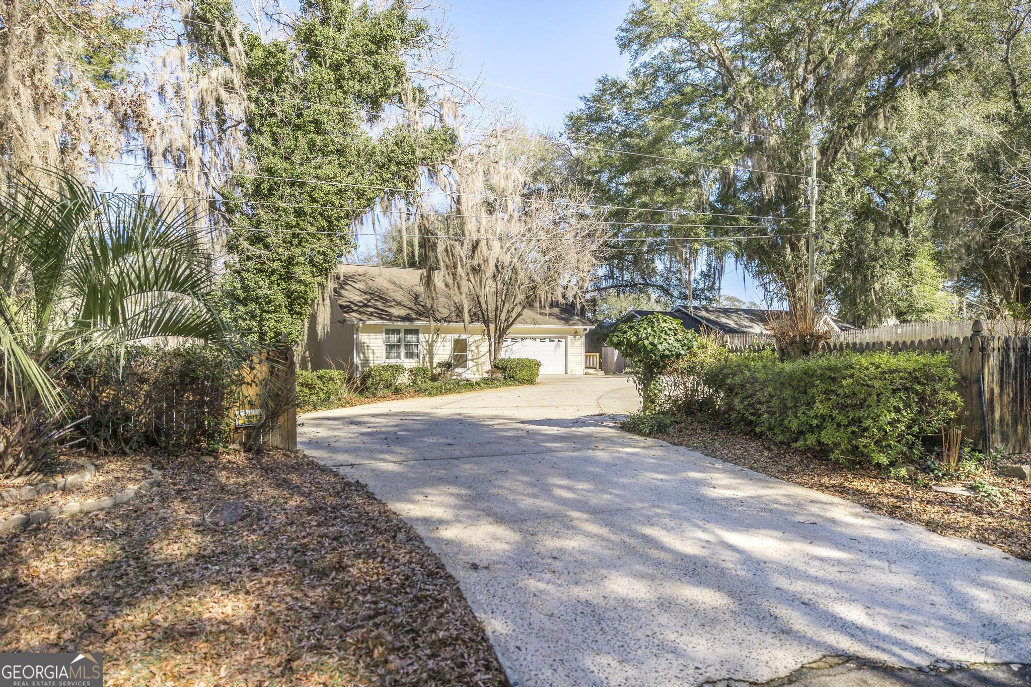 240 Mossland Drive Perry, GA 31069 - Photo 3 of 36 a view of a road with plants and large trees