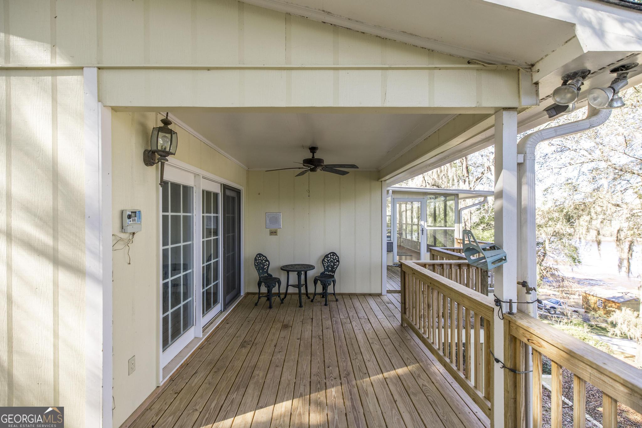 240 Mossland Drive Perry, GA 31069 - Photo 32 of 36 a view of a balcony with chairs and wooden floor