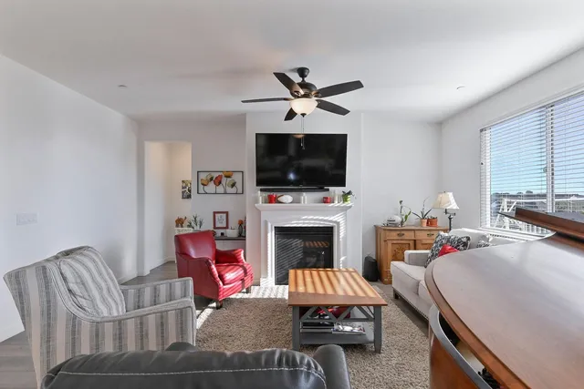 a living room with furniture and kitchen view