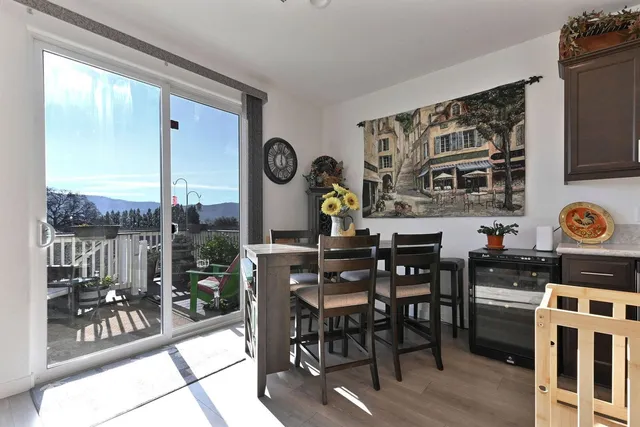 a living room with furniture a clock on wall and a window