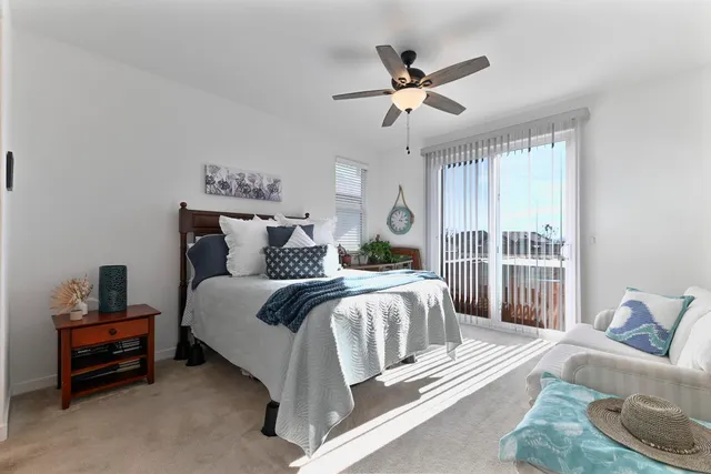 a large bed sitting in a bedroom next to a window