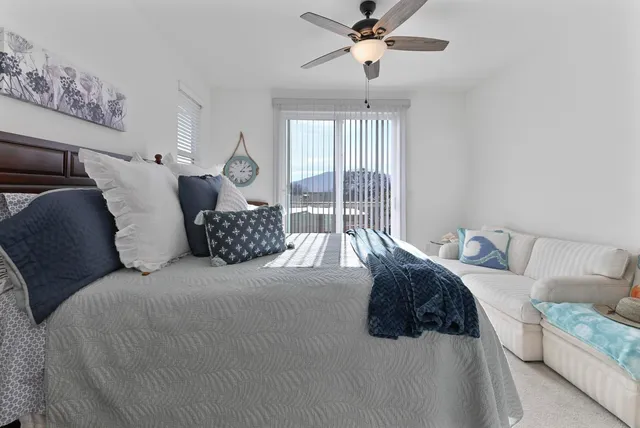 a bedroom with a large bed and a chandelier
