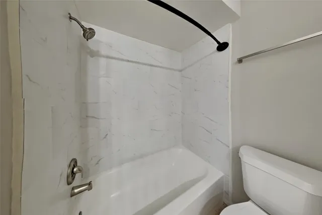 a bathroom with a bathtub and a toilet